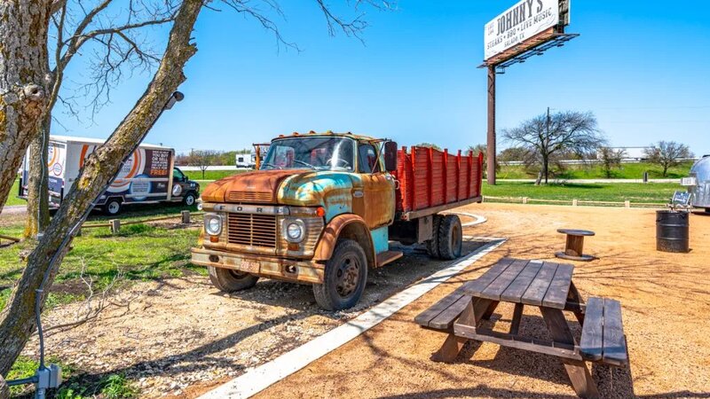 Rural Texas scene with vintage Ford truck near Johnny's BBQ in Jarrell, Texas