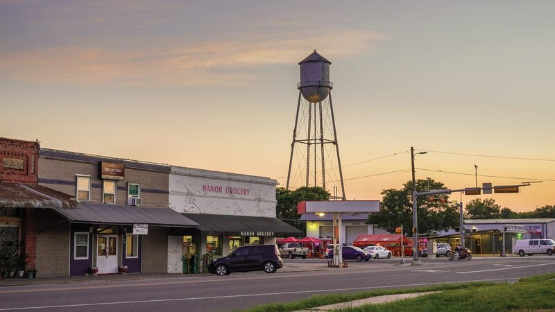 Downtown Manor, Texas at sunset with historic water tower and Manor Grocery