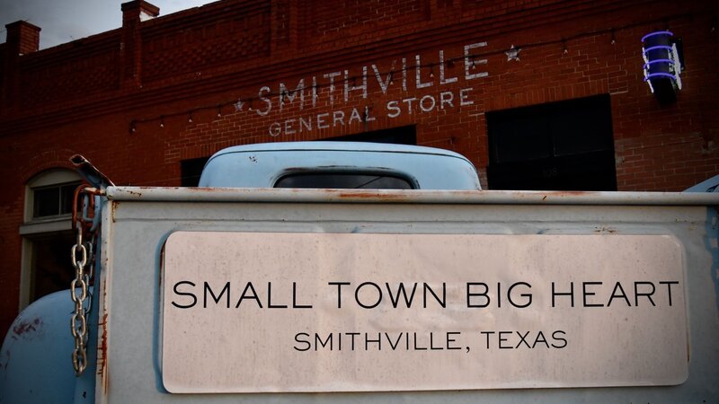 Vintage truck at Smithville General Store with Small Town Big Heart sign in Smithville, Texas